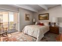 Cozy bedroom with balcony access and ample natural light at 8060 E Girard Ave # 719, Denver, CO 80231