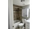 Updated bathroom with a tub, shower, and white vanity at 4899 S Dudley St # 1E, Littleton, CO 80123