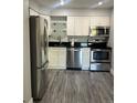 Modern kitchen featuring stainless steel appliances and white cabinets at 4899 S Dudley St # 1E, Littleton, CO 80123