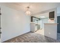 Dining area with light fixture and kitchen view at 1777 S Pitkin St # B, Aurora, CO 80017