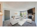 Living room with fireplace, staged furniture, and carpet at 1777 S Pitkin St # B, Aurora, CO 80017