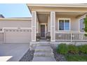 Charming home exterior, featuring a welcoming front porch and landscaping at 17920 E Emilia Dr, Parker, CO 80134