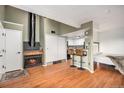 Open living room with a fireplace, kitchen, and bedroom visible at 8701 Huron St # 1-210, Thornton, CO 80260