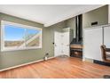 Living room with a fireplace and wood flooring, view of the front door at 8701 Huron St # 1-210, Thornton, CO 80260