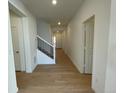 Light and bright hallway with light hardwood floors at 12926 Range St, Firestone, CO 80107