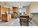 Kitchen with oak cabinets, stainless steel appliances, and an island at 17769 E Iowa Dr, Aurora, CO 80017