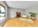 Living room featuring hardwood floors, large window, and electric fireplace at 17769 E Iowa Dr, Aurora, CO 80017
