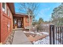 Inviting front entrance with a walkway, landscaping, and a cozy seating area at 333 Buena Vista Ave, Palmer Lake, CO 80133