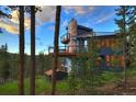 Modern mountain home with a deck and mountain views in the background at 141 Shekel Ln, Breckenridge, CO 80424