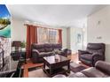 Bright living room with hardwood floors and ample natural light at 15768 E Center Pl, Aurora, CO 80017