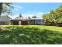 Large grassy backyard with a view of the back of the house at 1204 S Salida Way, Aurora, CO 80017