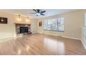 Living room featuring hardwood floors and brick fireplace at 7041 S Quince St, Centennial, CO 80112