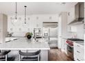 Modern kitchen with large island, stainless steel appliances, and white cabinets at 5060 Willow St, Denver, CO 80238