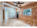 Bright living room featuring hardwood floors and wood-paneled walls at 192 Signal Rock Rd, Golden, CO 80403