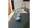 Kitchen with double sink, new smoke detectors, and gray countertops at 2043 S Salida St, Aurora, CO 80013
