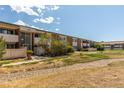 Full condo building view with landscaping and pathway at 5122 Williams Fork Trl # 201, Boulder, CO 80301