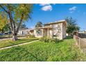 House exterior showcasing a ranch style home with a tree and lawn at 6681 Bellaire St, Commerce City, CO 80022