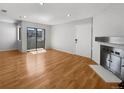 Living room with hardwood floors and sliding glass door to balcony at 1830 Newland Ct # 323, Lakewood, CO 80214