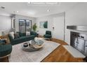 Virtually staged living room with fireplace and hardwood floors at 1830 Newland Ct # 323, Lakewood, CO 80214