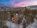 Aerial view of log cabin nestled in snowy mountains at 878 American Way, Breckenridge, CO 80424