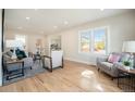 Light-filled living room with hardwood floors and comfortable seating at 6983 W 68Th Ave, Arvada, CO 80003