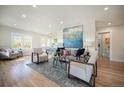 Bright and airy living room with hardwood floors and ample natural light at 6983 W 68Th Ave, Arvada, CO 80003