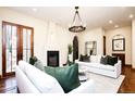 Bright living room features a fireplace, hardwood floors, and French doors leading to the backyard at 2435 S Milwaukee St, Denver, CO 80210