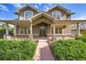 Two story home exterior with covered porch and landscaping at 920 Sunny Way, Lafayette, CO 80026