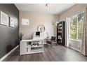 Modern home office with built-in shelving and a large desk at 6747 Raritan Dr, Denver, CO 80221