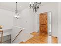 Bright and spacious entryway with hardwood floors and elegant chandelier at 4381 Cheyenne Dr, Larkspur, CO 80118