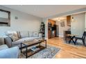 Open living room with hardwood floors and modern furniture at 2460 W Caithness Pl # 104, Denver, CO 80211