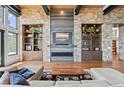 Spacious living room with stone fireplace and built-in shelving at 1082 W Meadow Rd, Evergreen, CO 80439