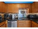 Modern kitchen with wood cabinets, granite counters, and stainless steel appliances at 1350 Josephine St # 401, Denver, CO 80206
