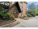 Brick building exterior with a wood entryway and landscaping at 1350 Josephine St # 401, Denver, CO 80206