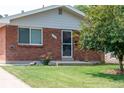 Brick ranch house with a well-maintained lawn at 177 Wolff St, Denver, CO 80219