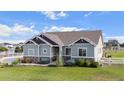 Ranch home with gray siding, landscaping and a two-car garage at 10790 E 163Rd Ct, Brighton, CO 80602