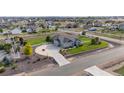 Aerial view of a ranch style home with a large yard and circular driveway at 10790 E 163Rd Ct, Brighton, CO 80602