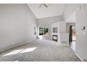 Spacious living room with vaulted ceilings, fireplace, and carpeting at 19873 E Vassar Ave, Aurora, CO 80013