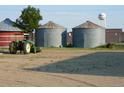 Farmland with grain bins and antique tractor at 2024 Strasburg Rd, Strasburg, CO 80136