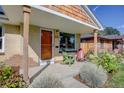 Brick Ranch home with a covered porch and well-manicured landscaping at 3339 S Ogden St, Englewood, CO 80113