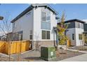 Two-story home exterior, showcasing front yard and wooden fence at 6257 N Nepal Ct, Aurora, CO 80019