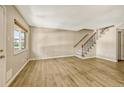 Living room with laminate floors and stairs at 6885 E Arizona Avenue # D, Denver, CO 80224