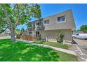 Townhouse exterior view showcasing landscaping and parking at 6885 E Arizona Avenue # D, Denver, CO 80224