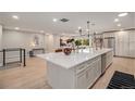 Modern kitchen with large island and white cabinets at 2395 W Davies Ave, Littleton, CO 80120