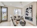 Bright living room with comfy seating and large windows at 2313 S High St, Denver, CO 80210