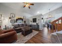 Spacious living room featuring hardwood floors, a gray couch, and a cozy atmosphere at 8736 Starwood Ln, Parker, CO 80134