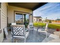 Relaxing covered patio with seating area, perfect for outdoor enjoyment at 830 W 128Th Pl, Westminster, CO 80234