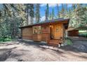 Charming wooden home with a spacious front yard at 28192 Shadow Mountain Dr, Conifer, CO 80433
