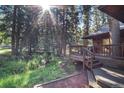 Home's back deck overlooks a stream and wooded area, creating a serene atmosphere at 28192 Shadow Mountain Dr, Conifer, CO 80433