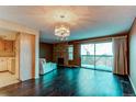 Living room with hardwood floors, fireplace, and access to balcony at 62 S Holman Way # 62, Golden, CO 80401